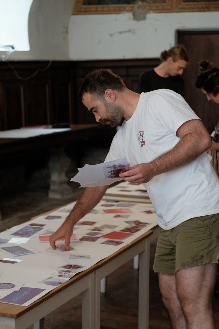 A participant sorting images printed on transparent paper along a table