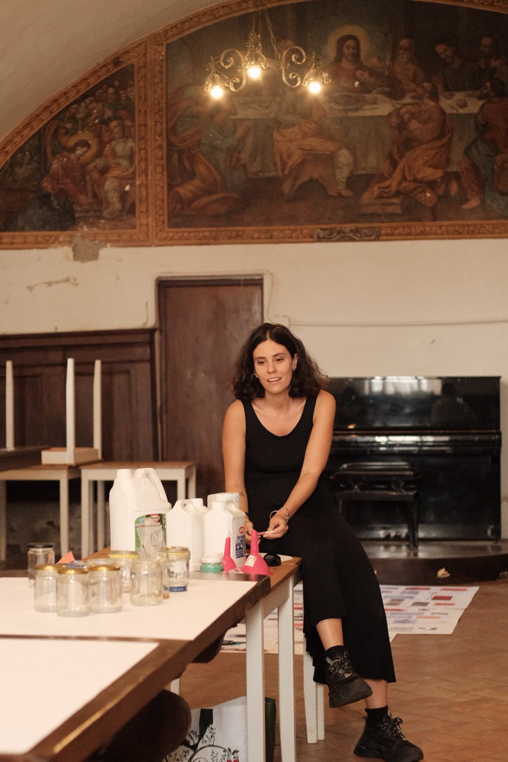 Workshop table with jars and containers of chemicals in the convent hall